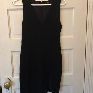 Sleeveless black minidress with side slit